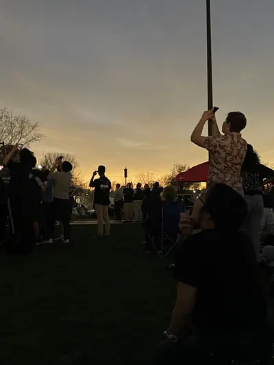 photo of people silhouetted against a twilight sky